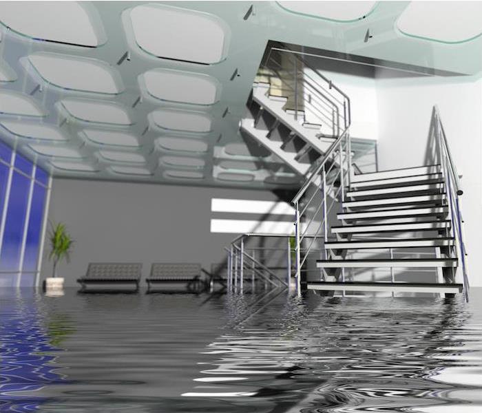 flooding in large room with staircase partially submerged in water